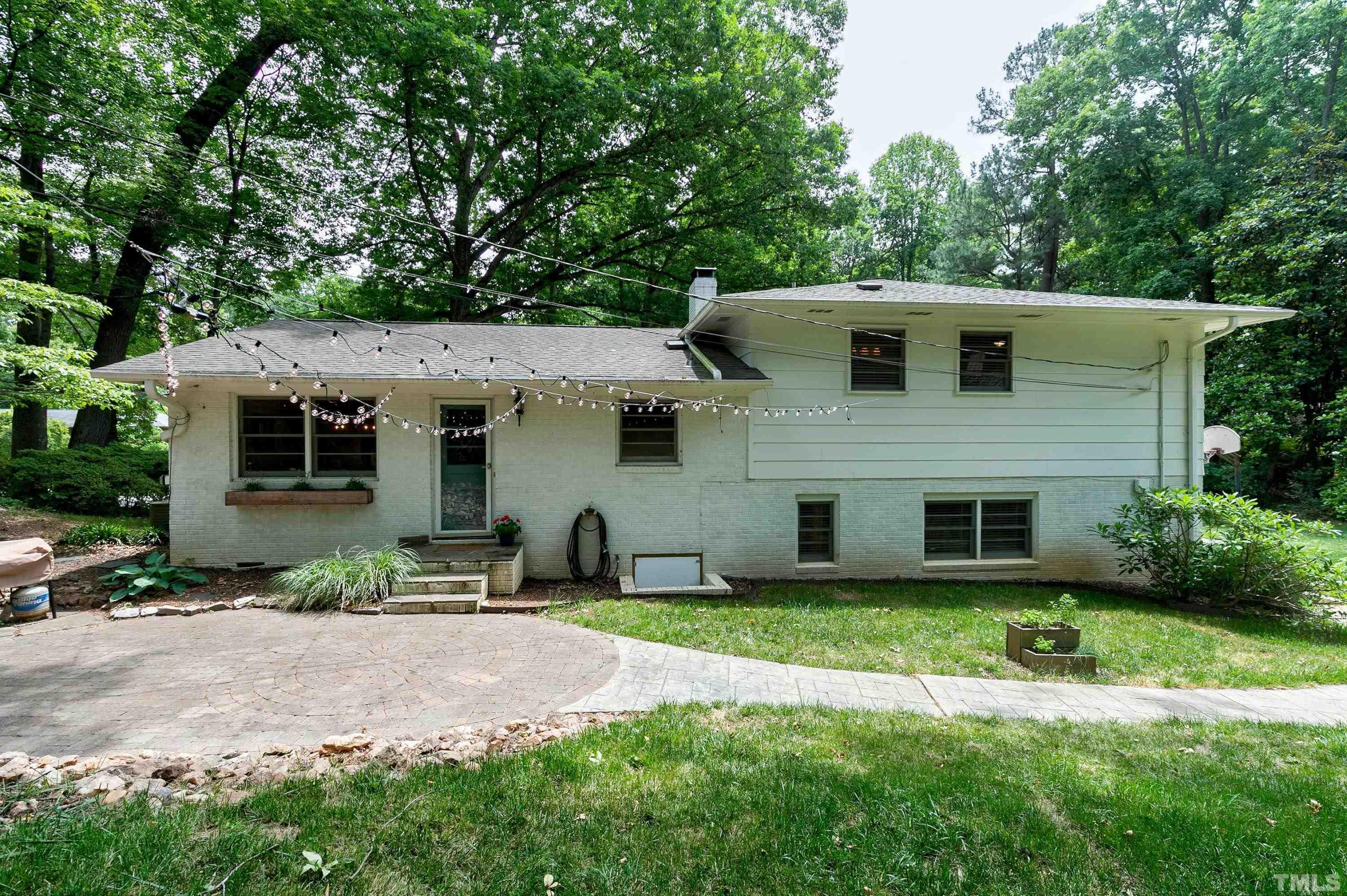 1300 Kingston Ridge Road Cary, NC 27511 - Photo 34 of 40 a front view of a house with a yard and garage