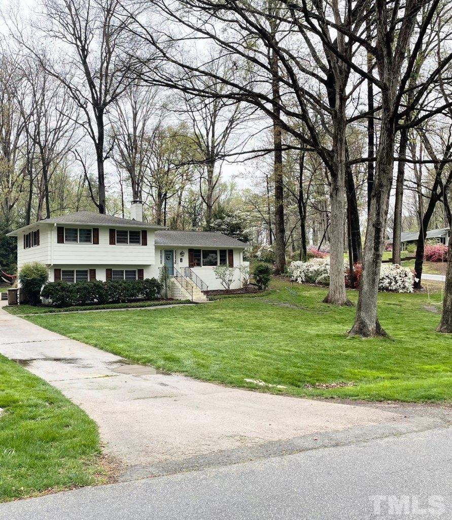 1300 Kingston Ridge Road Cary, NC 27511 - Photo 40 of 40 a front view of a house with a garden and trees