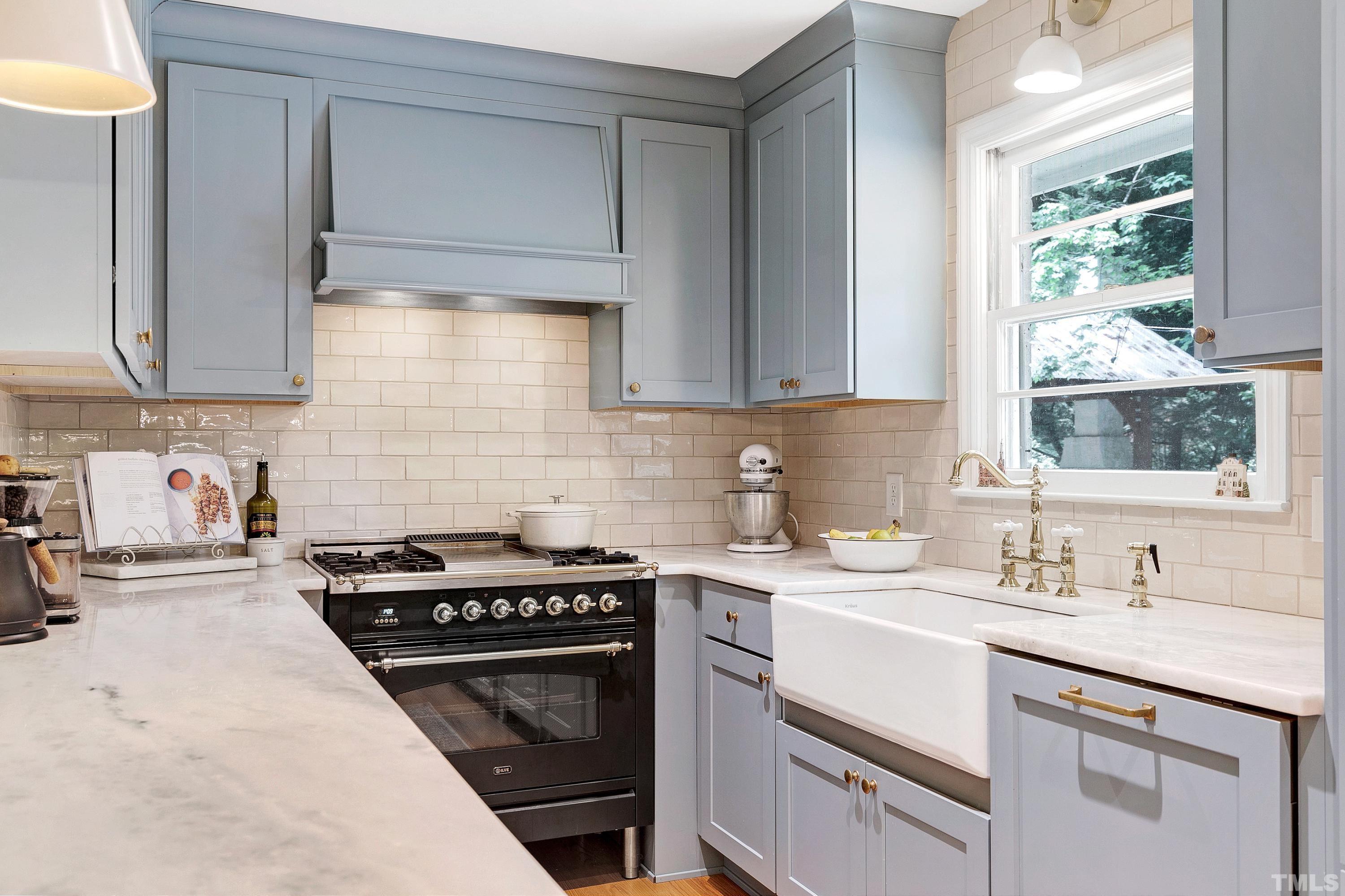 1300 Kingston Ridge Road Cary, NC 27511 - Photo 10 of 40 a kitchen with stainless steel appliances a sink stove and cabinets