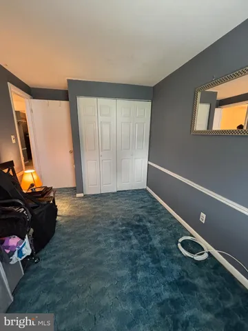 a living room with furniture gym equipment and a large window