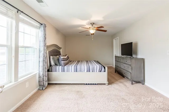 a view of a livingroom with a flat screen tv and windows