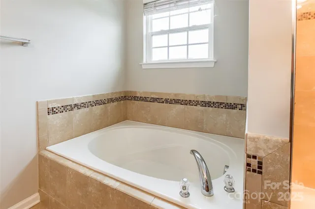 a white bath tub sitting in a bathroom
