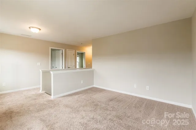 a view of an empty room and a window