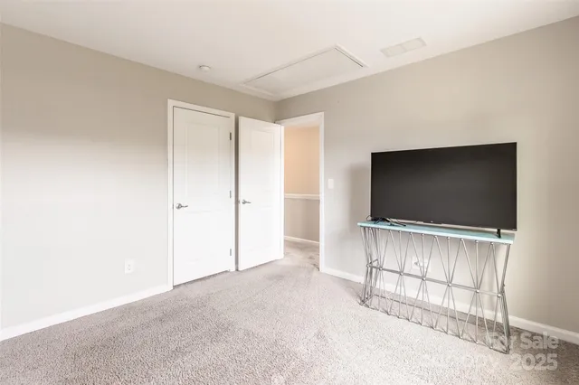 a view of a livingroom with entryway wooden floor and cabinet
