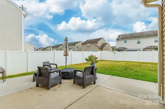 a view of a patio with a table and chairs