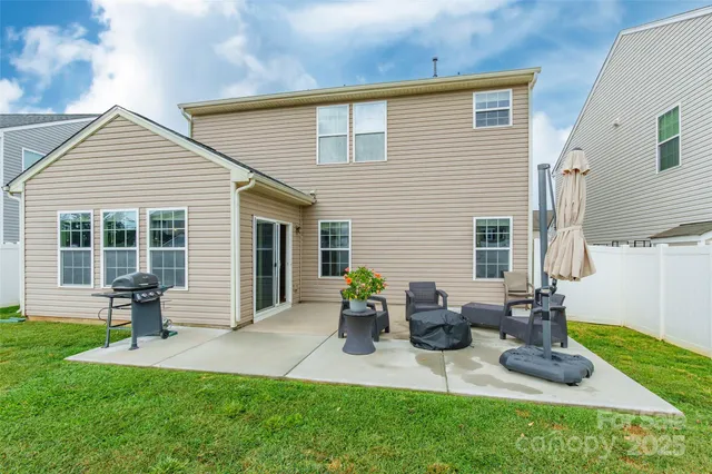 a front view of house with yard and outdoor seating
