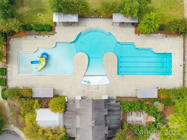an aerial view of a house with a yard basket ball court and outdoor seating