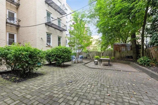 a view of a patio with table and chairs and potted plants