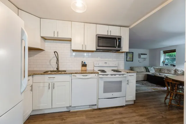 a kitchen with appliances a sink and cabinets