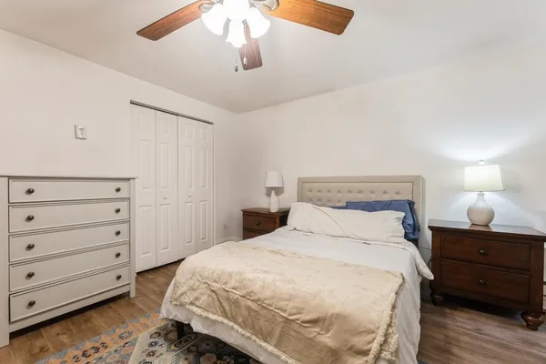 a bedroom with a bed and a night stand