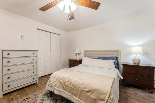 a bedroom with a bed and a night stand