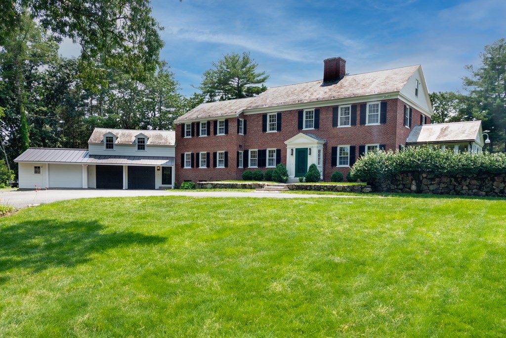 35 Sandy Pond Road Lincoln, MA 01773 - Photo 1 of 40 a front view of a house with a garden and swimming pool