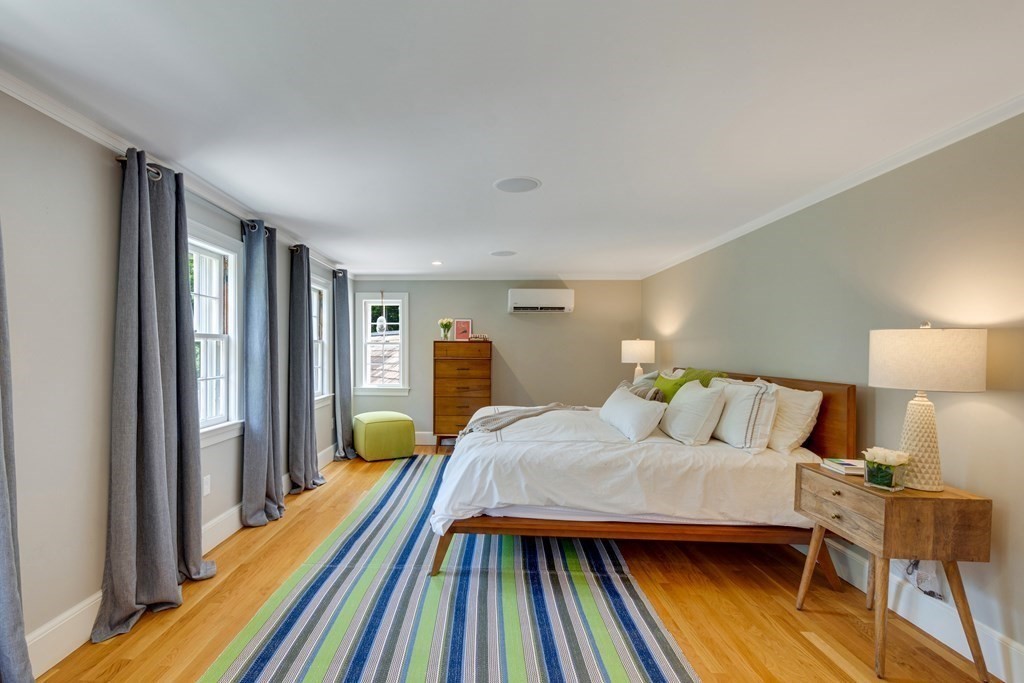 35 Sandy Pond Road Lincoln, MA 01773 - Photo 17 of 40 a bedroom with a bed and wooden floor