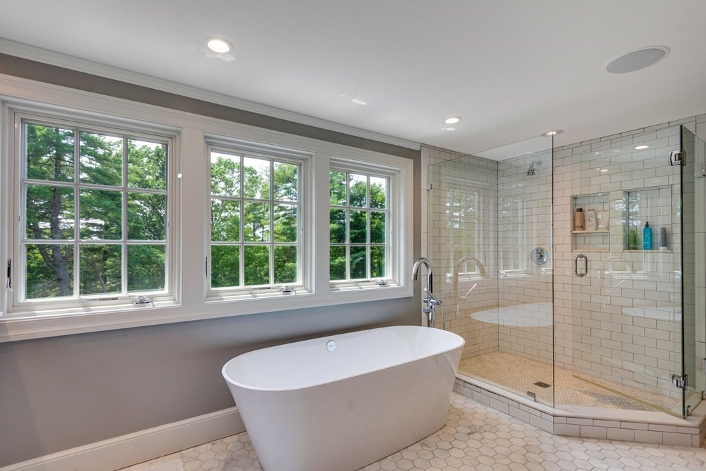 35 Sandy Pond Road Lincoln, MA 01773 - Photo 19 of 40 a white bath tub sitting in a bathroom next to a window