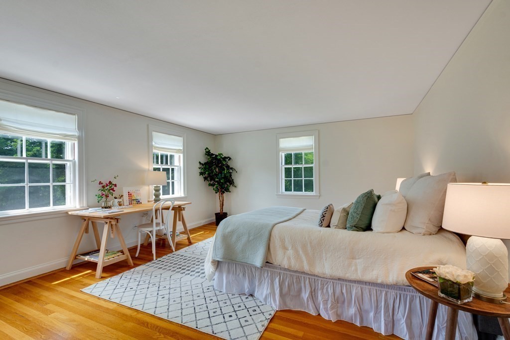 35 Sandy Pond Road Lincoln, MA 01773 - Photo 21 of 40 a room with a bed a table and chair