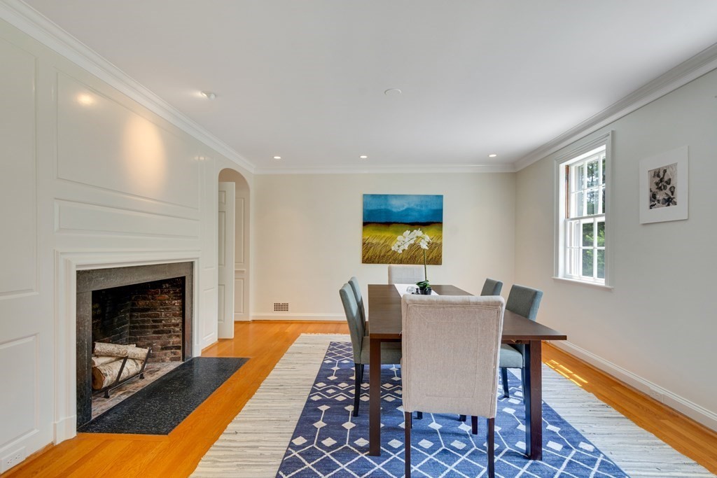 35 Sandy Pond Road Lincoln, MA 01773 - Photo 3 of 40 a dining room with furniture a fireplace and wooden floor