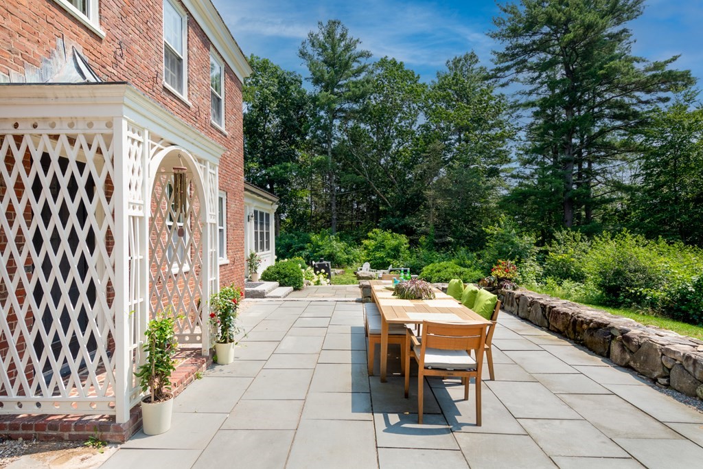 35 Sandy Pond Road Lincoln, MA 01773 - Photo 31 of 40 a view of a patio with a table and chairs and potted plants