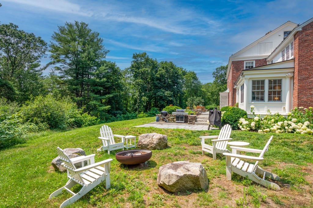 35 Sandy Pond Road Lincoln, MA 01773 - Photo 32 of 40 a view of a swimming pool with lawn chairs and a fire pit