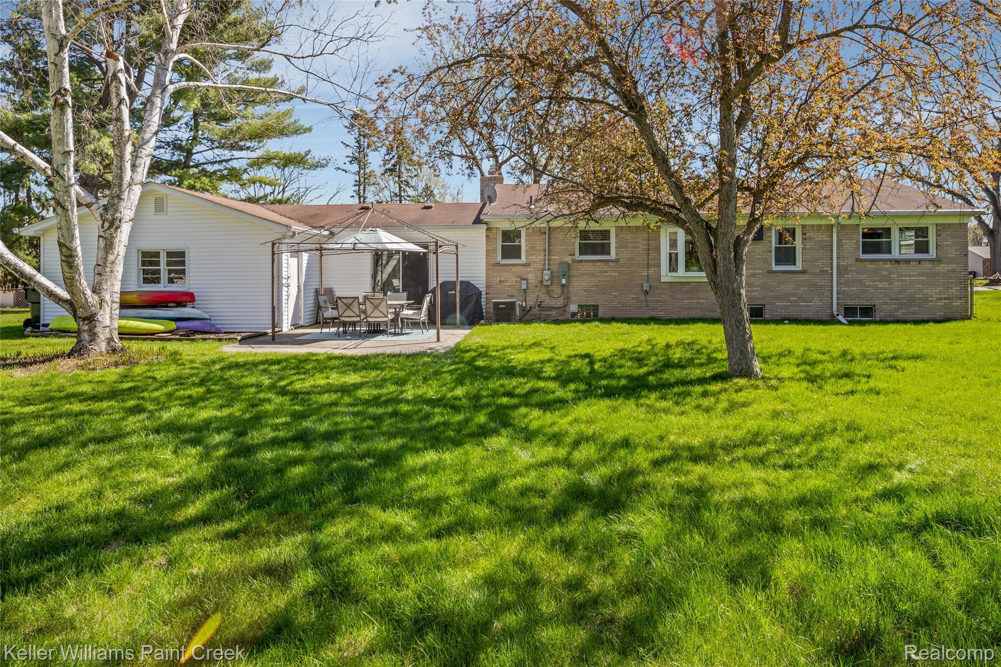 310 Elmhill Road Rochester, MI 48306 - Photo 33 of 37 Back of property with brick siding, a patio area, a lawn, a chimney, and a gazebo