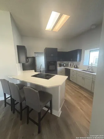 a kitchen with a table chairs and a refrigerator