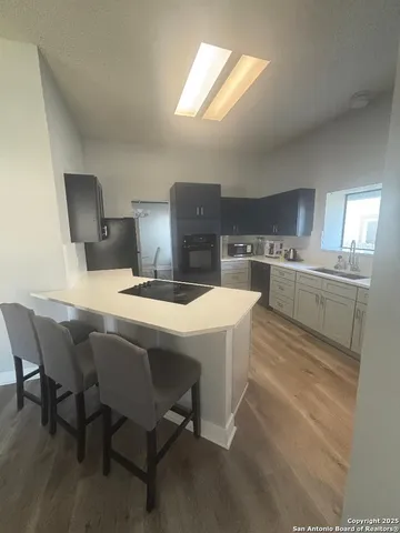 a kitchen with a table chairs and a refrigerator