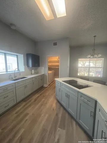 a large kitchen with a sink and cabinets