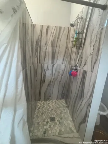 a view of a closet with wooden floor