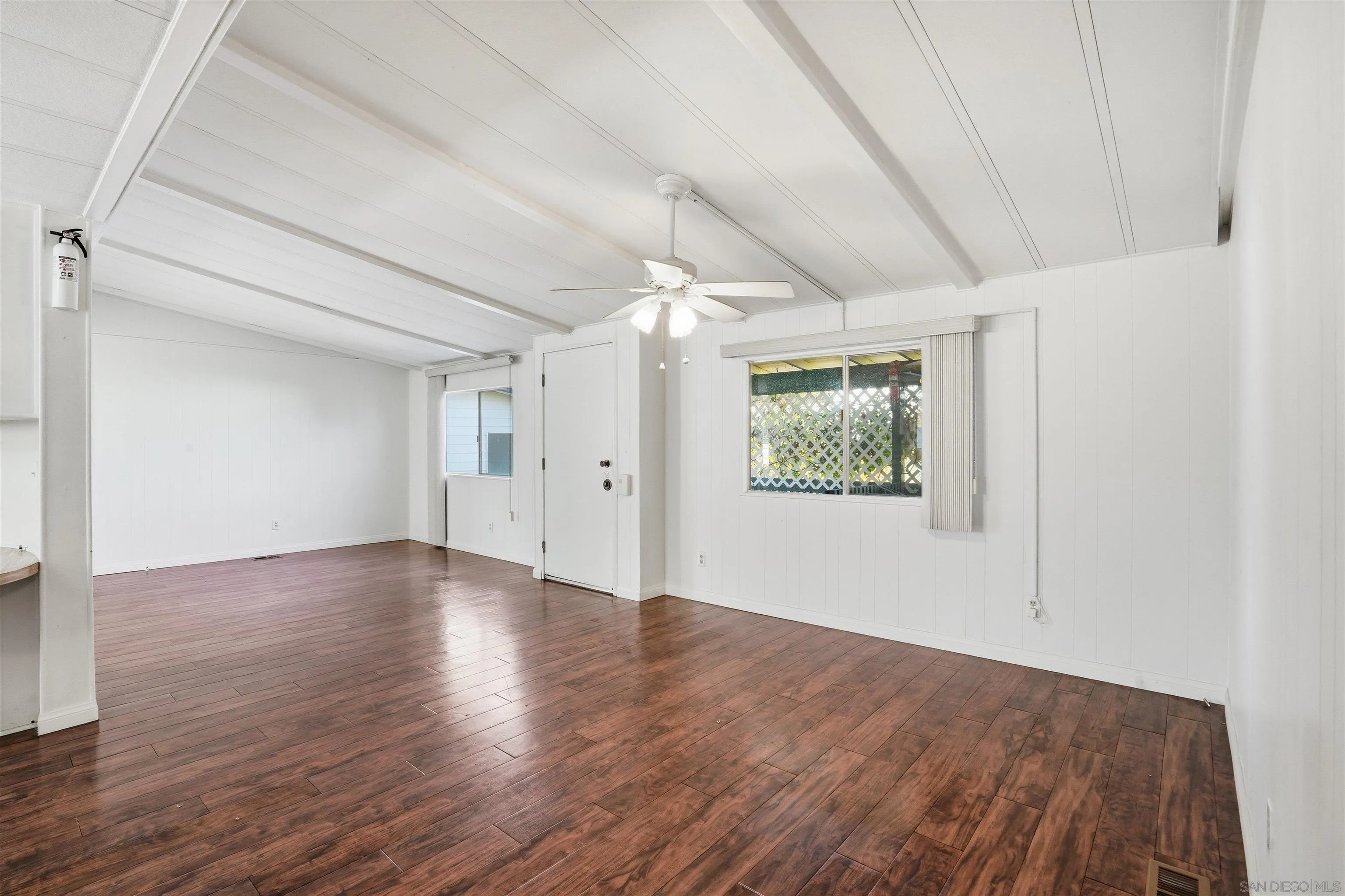 9255 North Magnolia Avenue, Unit 339 Santee, CA 92071 - Photo 25 of 51 a view of an empty room with wooden floor and a window