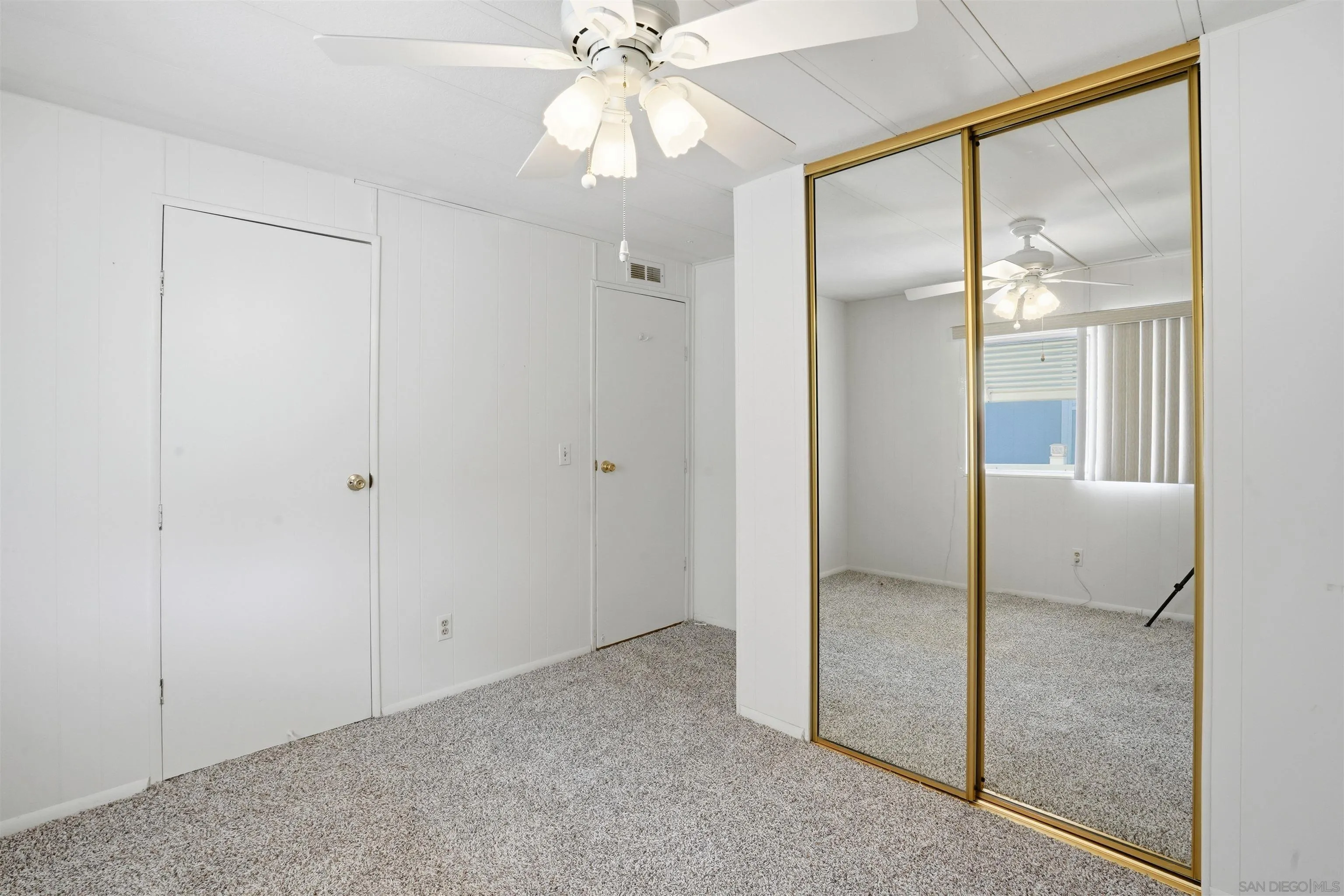 9255 North Magnolia Avenue, Unit 339 Santee, CA 92071 - Photo 31 of 51 an empty room with a mirror and a fan