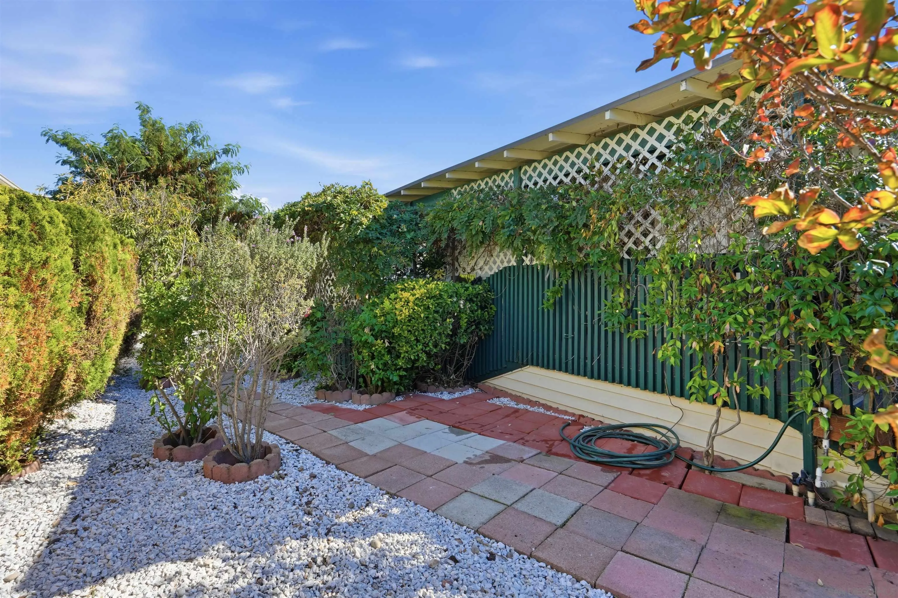 9255 North Magnolia Avenue, Unit 339 Santee, CA 92071 - Photo 9 of 51 a view of a backyard with potted plants and large trees