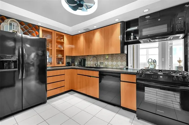 a kitchen with stainless steel appliances granite countertop a refrigerator and a stove