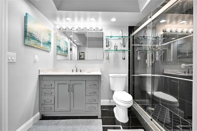 a bathroom with a sink a toilet and shower