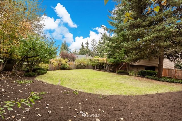 a swimming pool with trees in the background