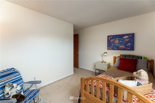 a bedroom with furniture and wooden floor