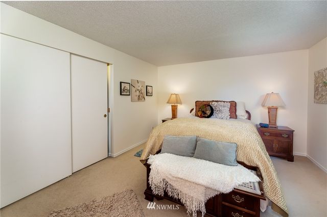 a bedroom with a bed and a night stand