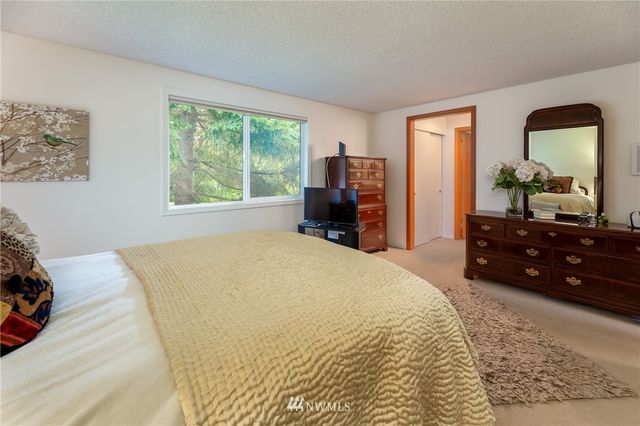 a bed sitting in a bedroom next to a window