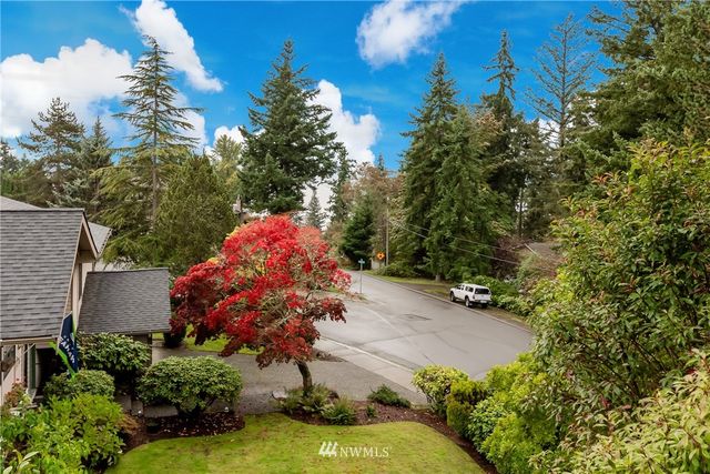 an aerial view of a house with yard