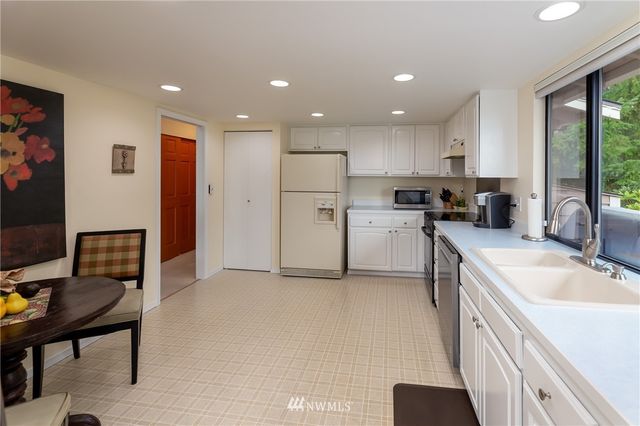 a kitchen with a sink appliances and cabinets