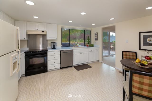 a kitchen with a sink stainless steel appliances and cabinets