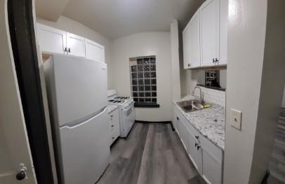 1958 Perrysville Avenue, Unit 1964 Pittsburgh, PA 15214 - Photo 2 of 9 a kitchen with white cabinets and white appliances