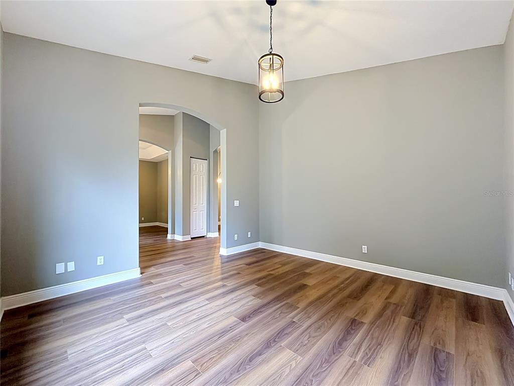 28549 Shirley Shores Road Tavares, FL 32778 - Photo 12 of 65 a view of a room with wooden floor and white walls