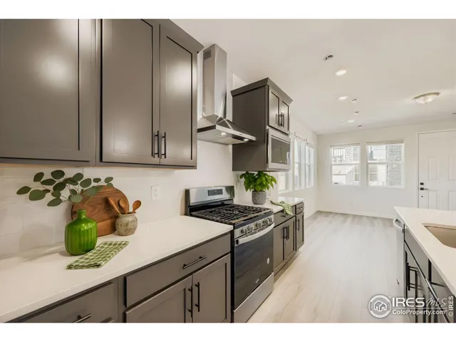 a bedroom with a bed a chandelier and a window