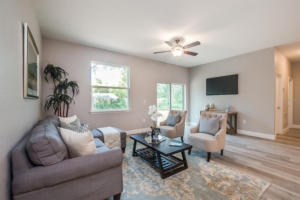 621 Paddock Street Orlando, FL 32833 - Photo 12 of 25 a living room with furniture and a flat screen tv