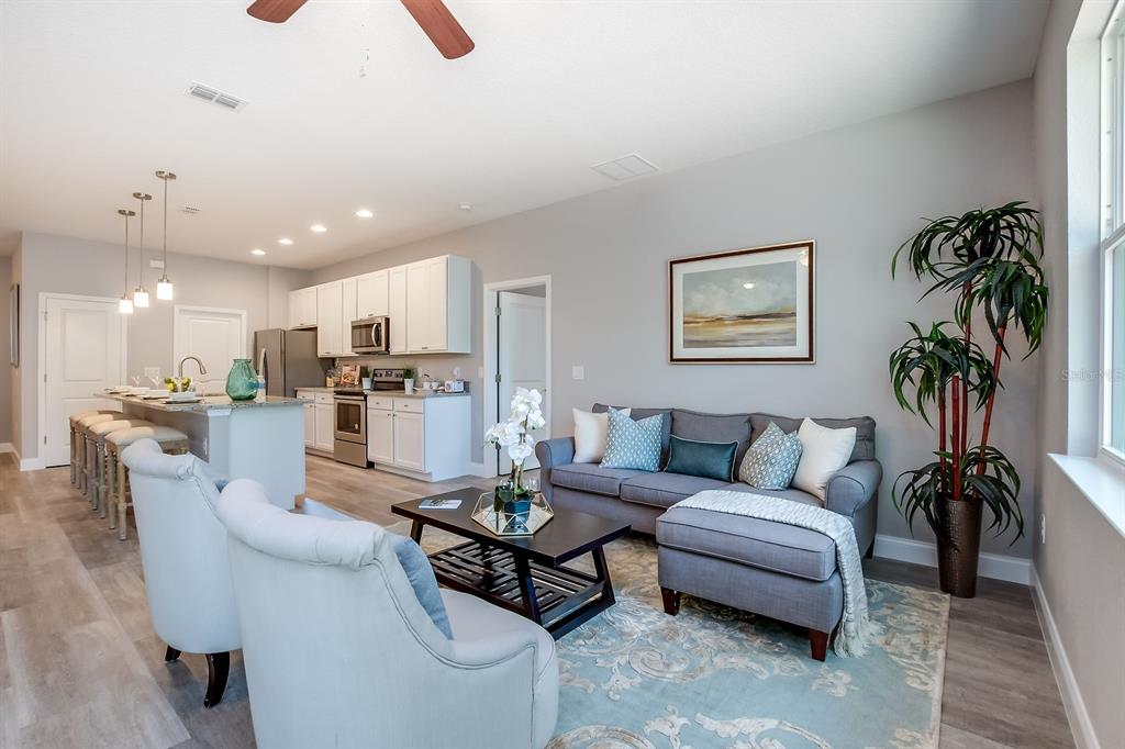 621 Paddock Street Orlando, FL 32833 - Photo 14 of 25 a living room with furniture and a dining table with kitchen view