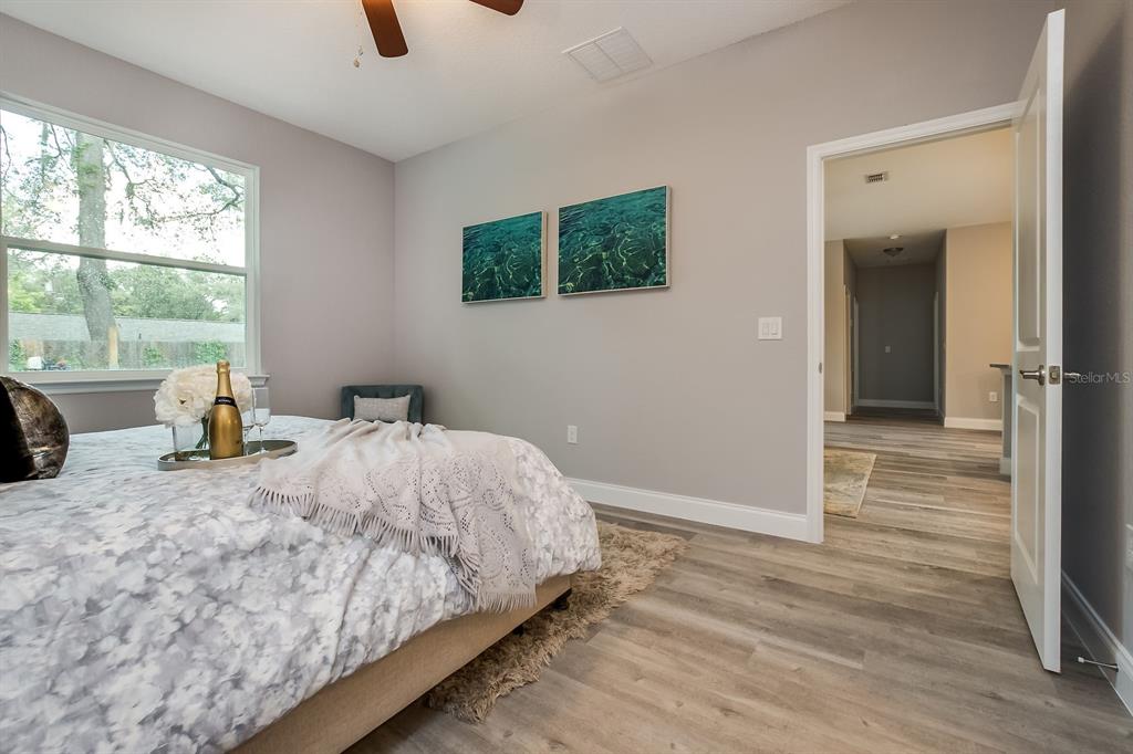 621 Paddock Street Orlando, FL 32833 - Photo 18 of 25 a bed sitting in a spacious bedroom next to a window