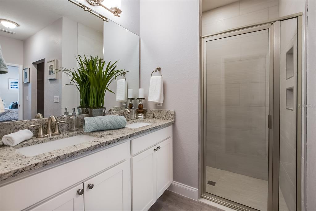 621 Paddock Street Orlando, FL 32833 - Photo 19 of 25 a bathroom with a granite countertop sink and a mirror