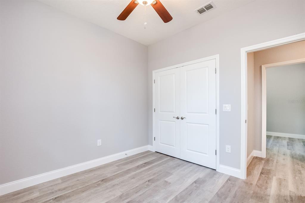 621 Paddock Street Orlando, FL 32833 - Photo 22 of 25 an empty room with wooden floor and window