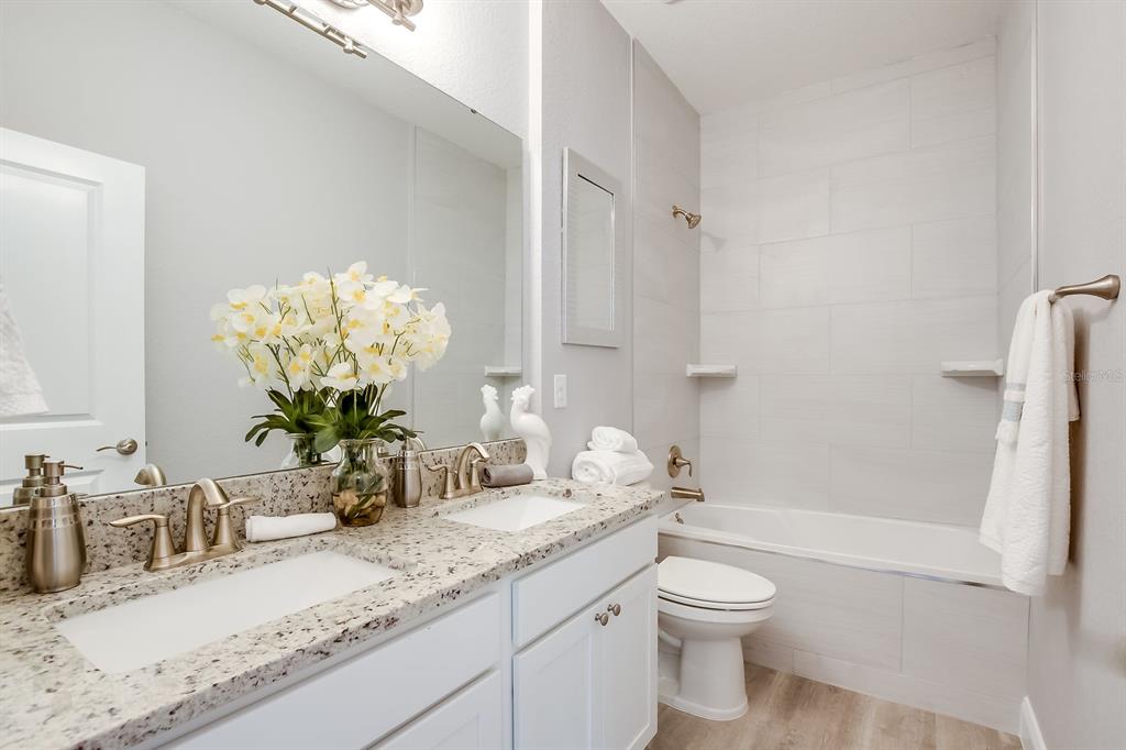 621 Paddock Street Orlando, FL 32833 - Photo 23 of 25 a bathroom with a granite countertop sink a toilet and shower