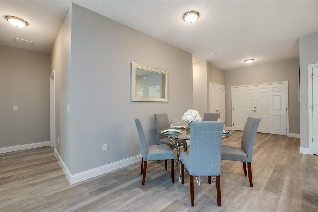 621 Paddock Street Orlando, FL 32833 - Photo 7 of 25 a view of a dining room with furniture and wooden floor