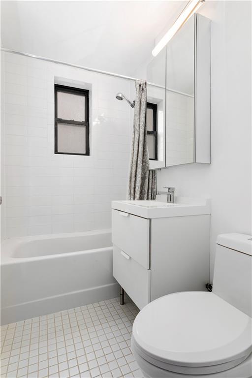 9511 Shore Road, Unit 101 Brooklyn, NY 11209 - Photo 7 of 8 a bathroom with a sink a toilet and shower